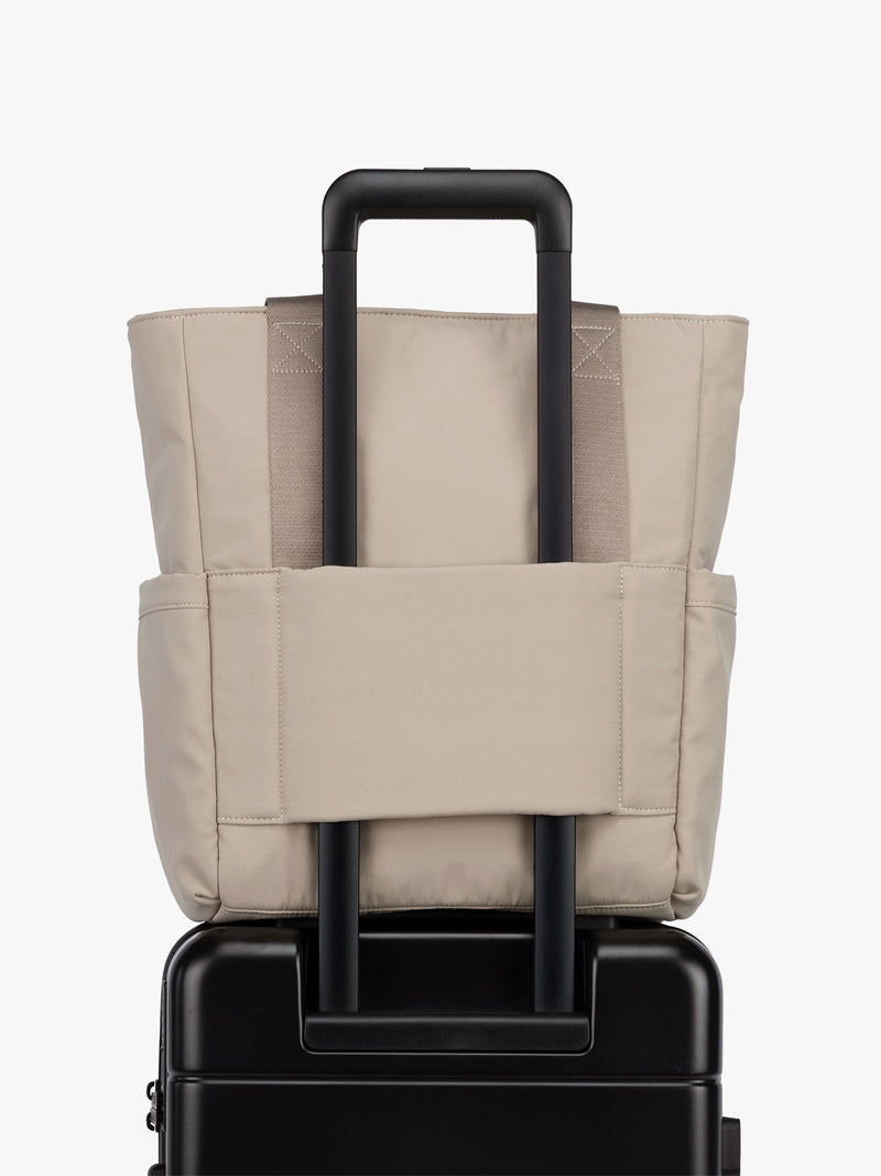CALPAK Zippered Laptop Tote Bag in beige Greige on a white background with trolley sleeve