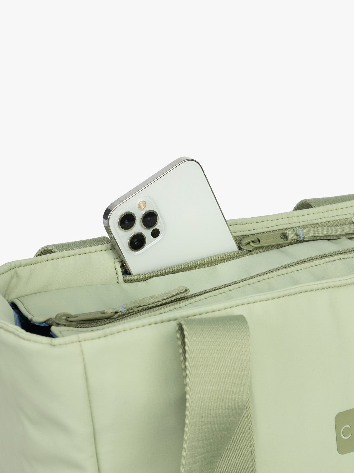 CALPAK Zippered Laptop Tote Bag in light green Meadow on a white background with phone pocket; TCN2501-MEADOW