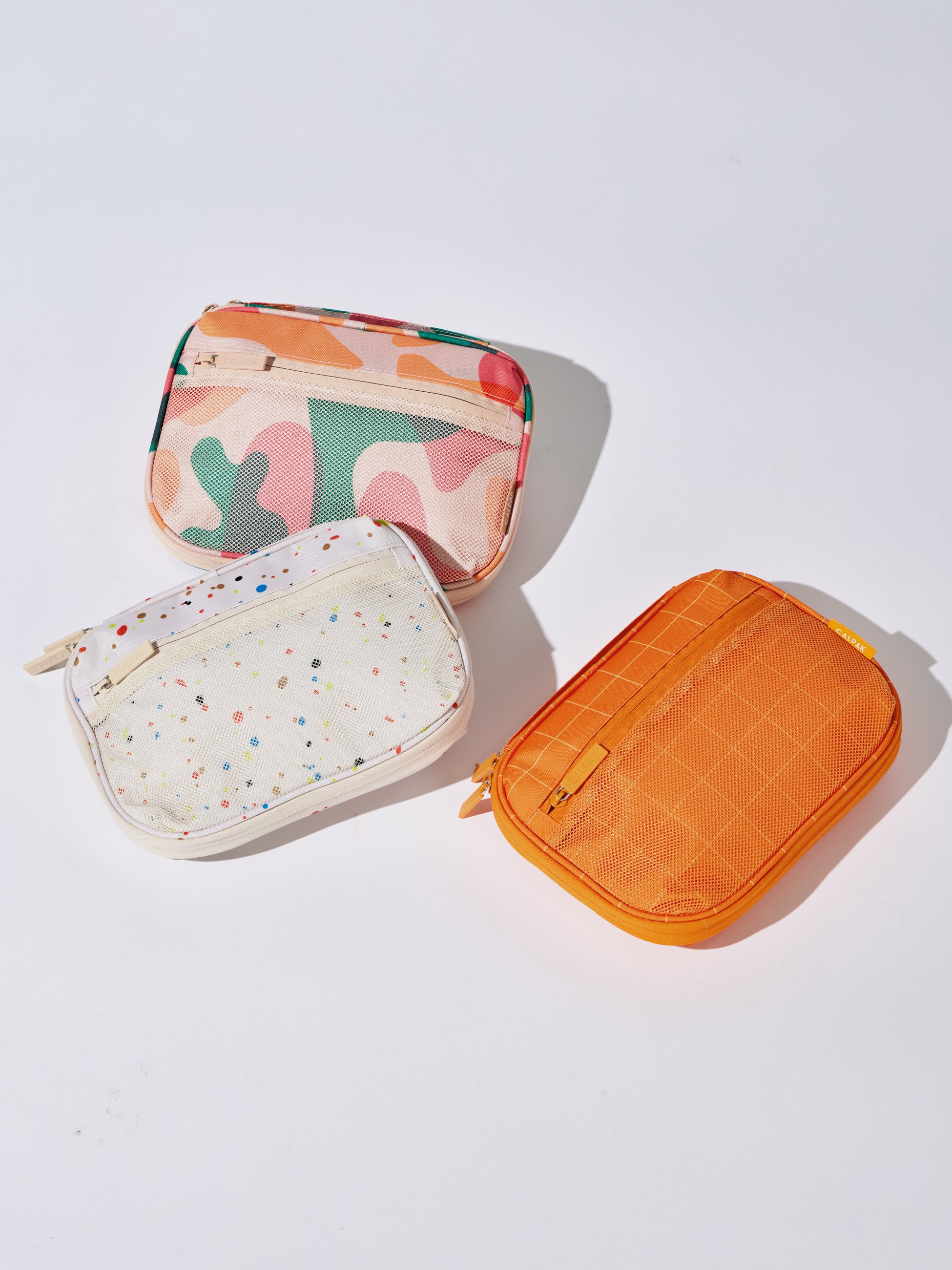 CALPAK tech and electronics organizers for school in modern abstract, speckle and orange grid