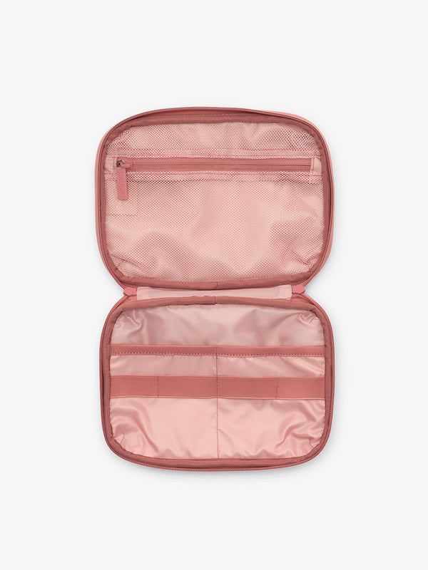 Interior view of tablet organizer in pink tea rose with loops and zippered pockets for organizing electronics and belongings