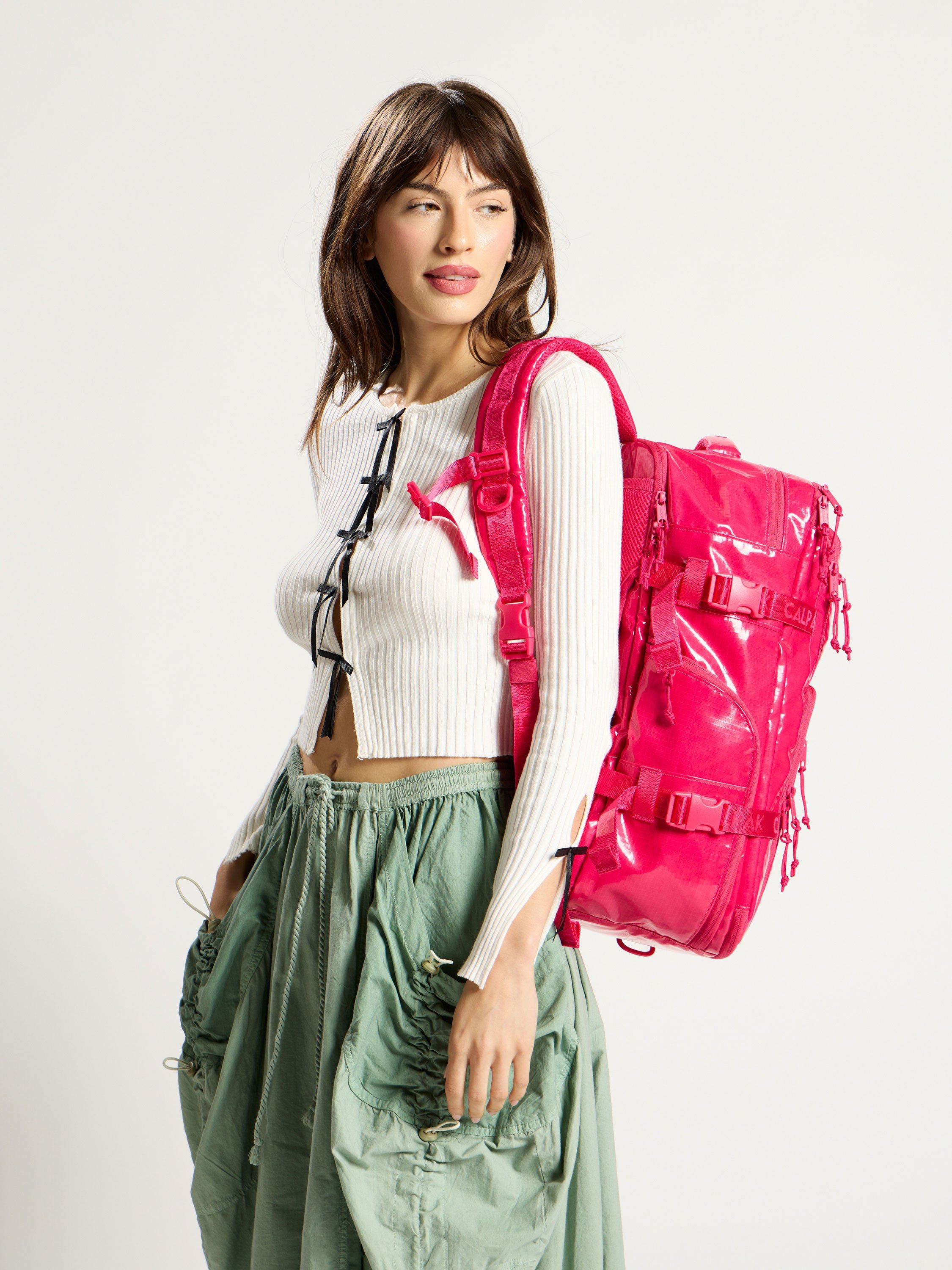 Model wearing CALPAK 26L Laptop Backpack Duffel in pink dragonfruit