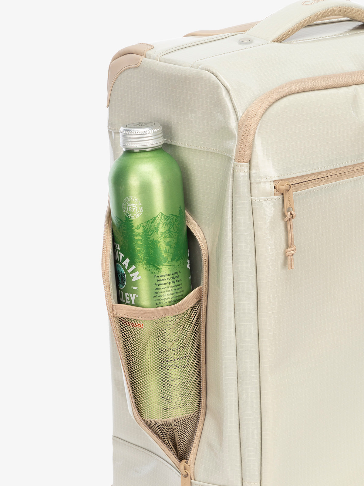Studio product shot of side bottle holder pocket of CALPAK Terra 35L Carry-On luggage with soft shell and 360 spinner wheels in white sands beige; LTR1020-WHITE-SANDS
