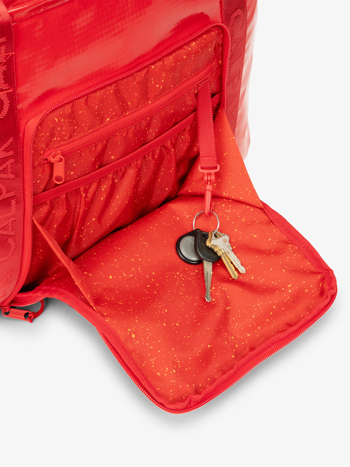CALPAK Terra 35L Water Resistant Tote Bag in red with opened pocket; TTO2401-FLAME