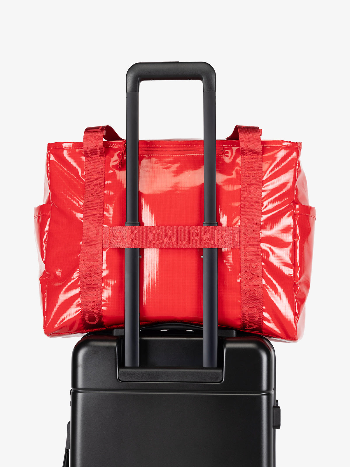 CALPAK Terra 35L Water Resistant Tote Bag in red with trolley sleeve; TTO2401-FLAME