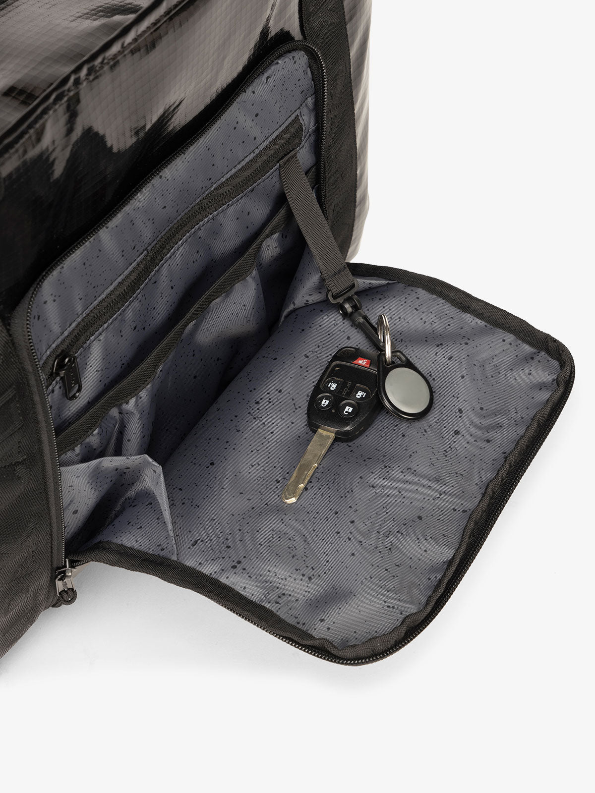 Black CALPAK terra 35L water resistant zippered tote bag with front organizational pocket for phone and personal items; TTO2401-OBSIDIAN