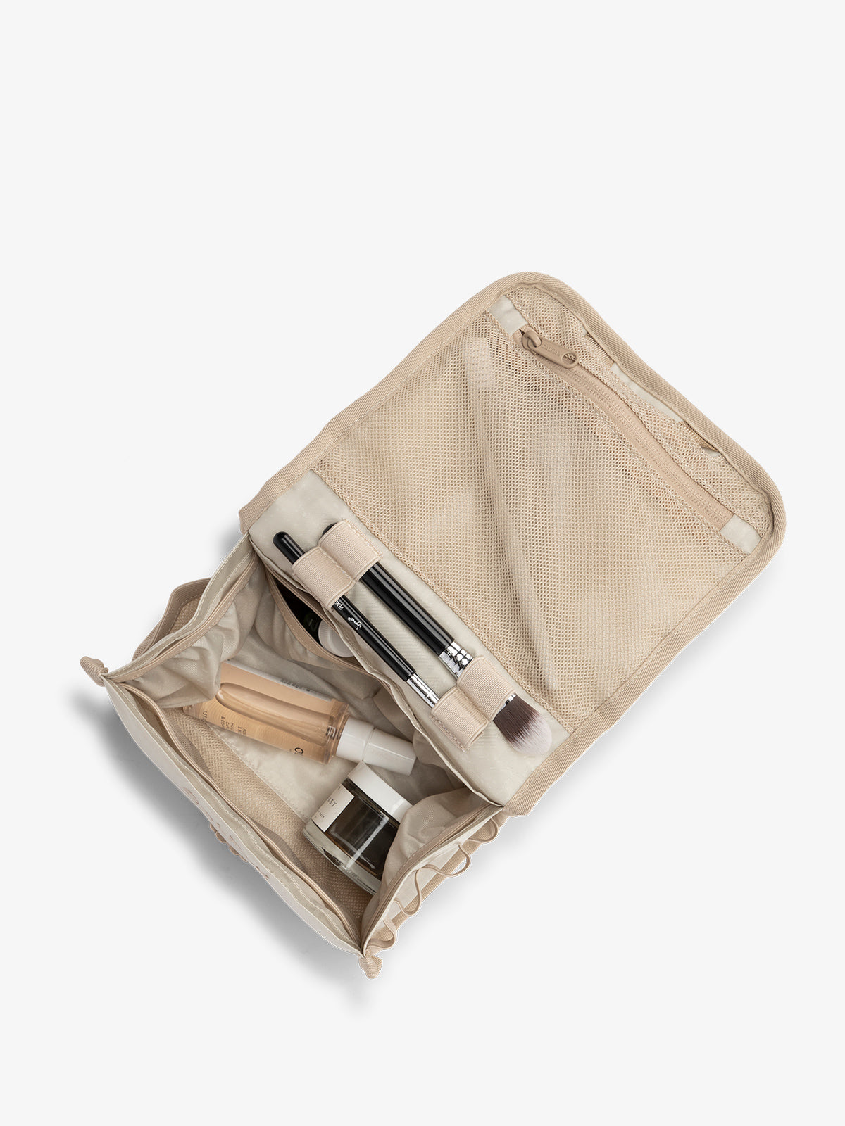 CALPAK Terra Hanging Travel Toiletry Bag with water-resistant interior and multiple pockets in white sands; THY2201-WHITE-SANDS