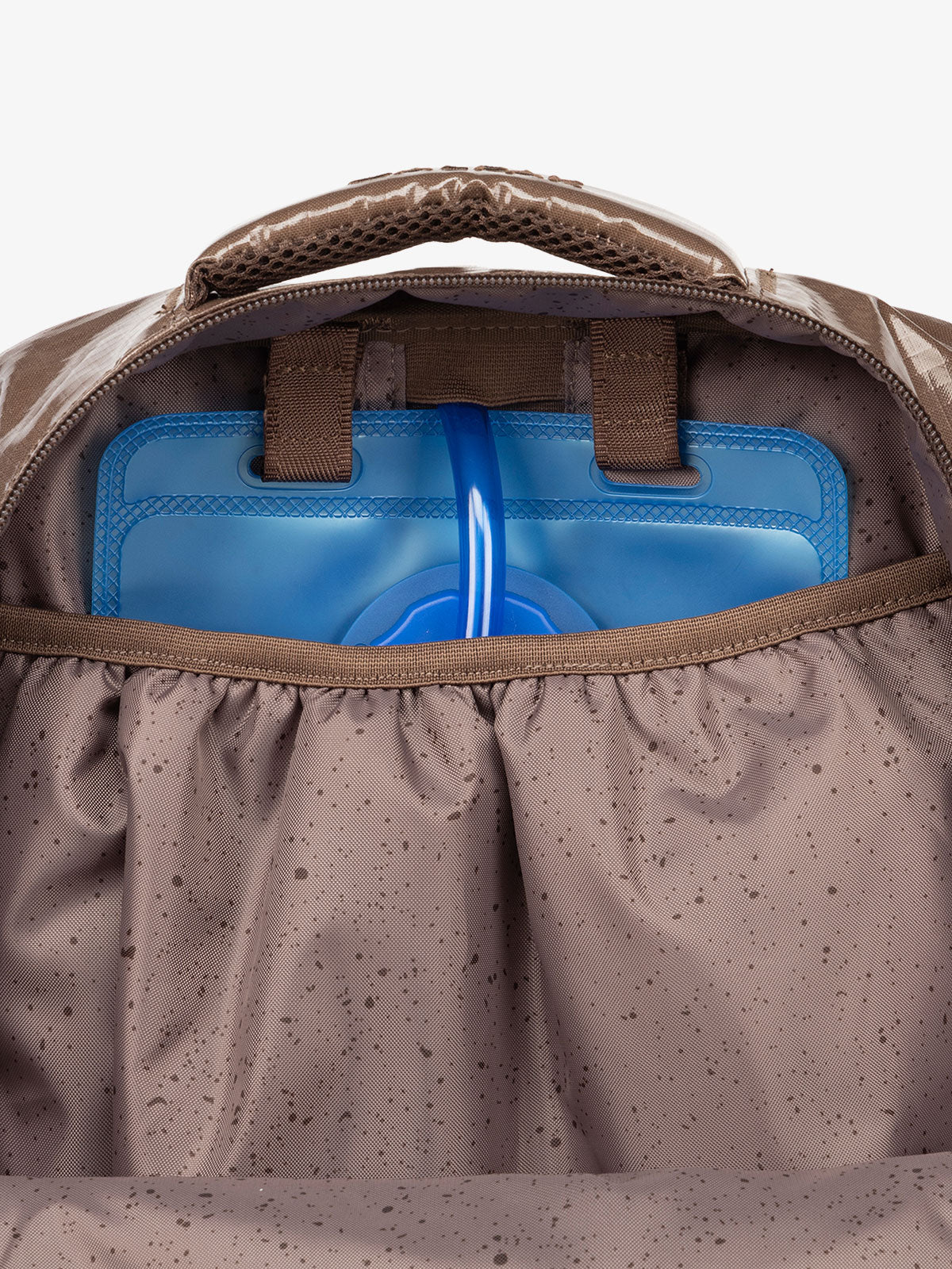 Close up of CALPAK 2L removable hydration reservoir back-slip pocket in brown cacao; BPT2201-CACAO