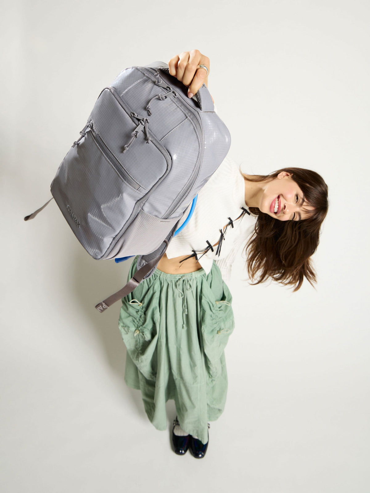 Model showing the CALPAK Terra Hydration Backpack for hiking; BPT2201-STORM