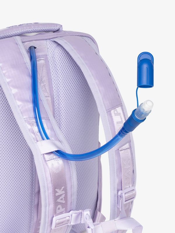 Close up of removable CALPAK hydration reservoir straw with valve cap in amethyst