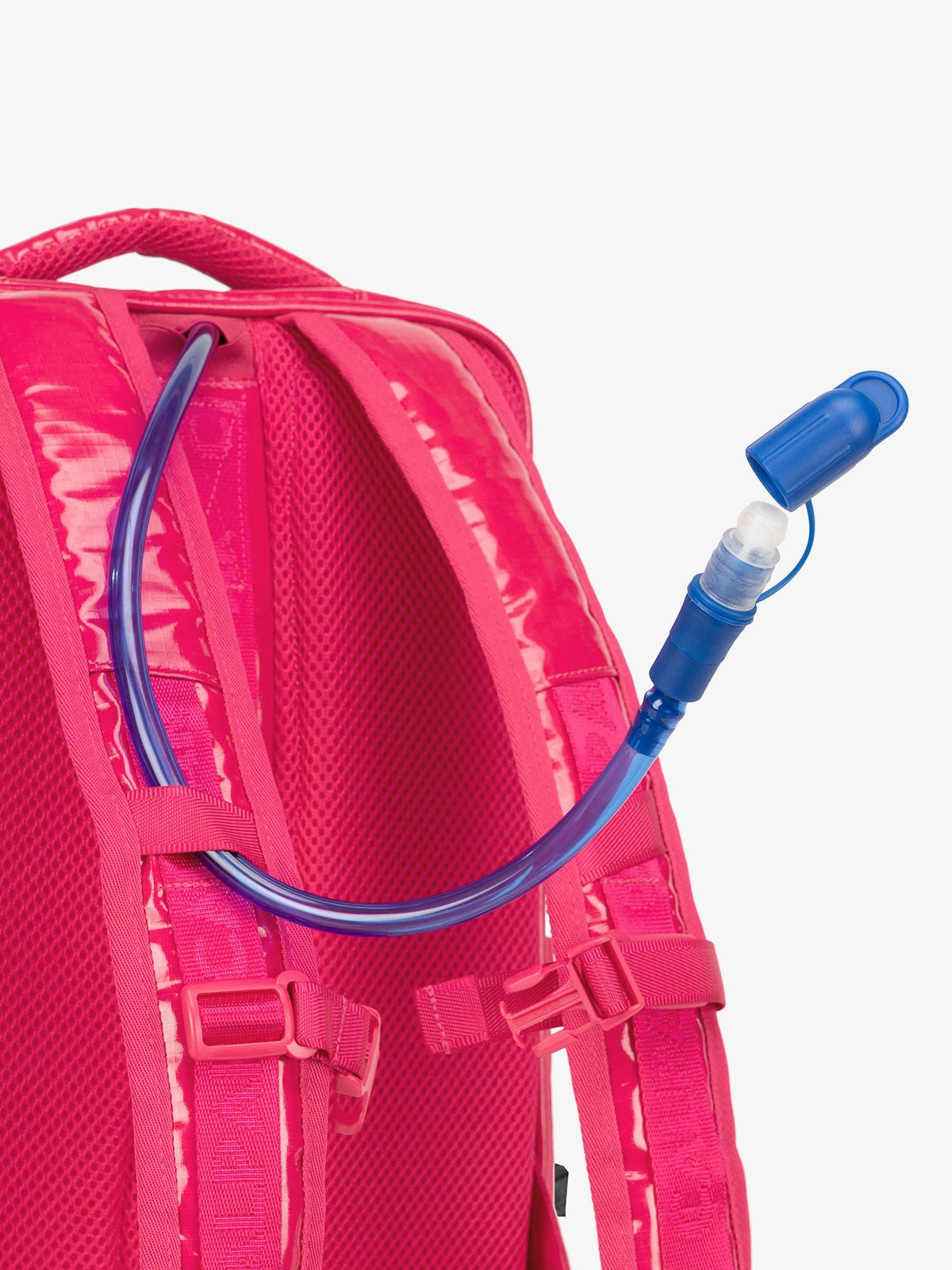 Close up of removable hydration reservoir straw with valve cap in pink