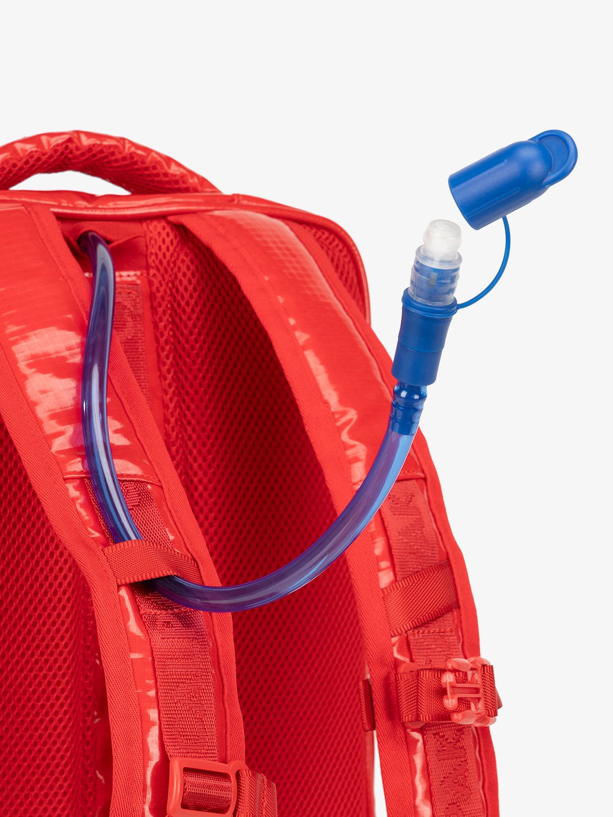 Close up of removable hydration reservoir straw with valve cap in red