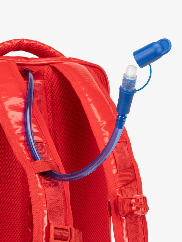Close up of removable CALPAK hydration reservoir straw with valve cap in red