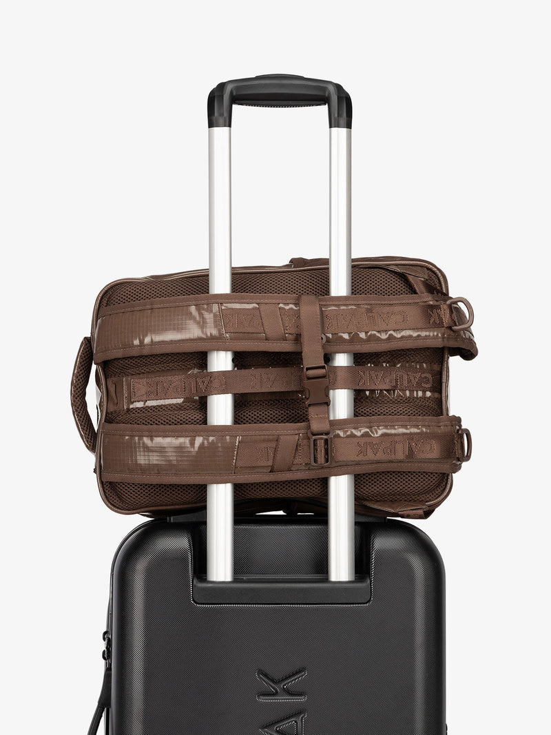 CALPAK hydration backpack with luggage trolley strap and and adjustable shoulder straps in brown