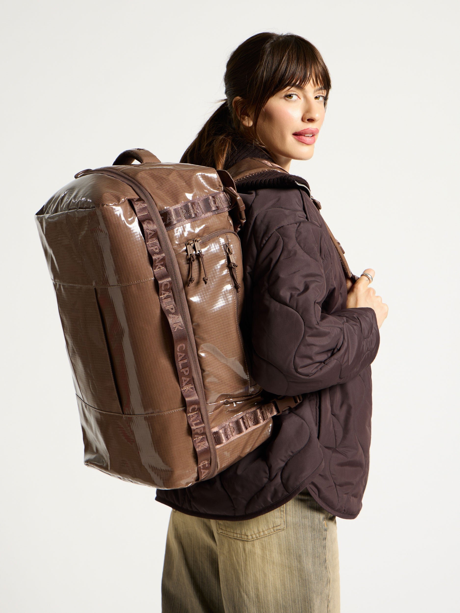Model wearing Terra Large 50L Duffel Backpack as backpack in cacao brown