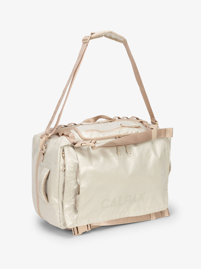 Beige white sands CALPAK terra large 50L duffel backpack with removable and adjustable body shoulder strap