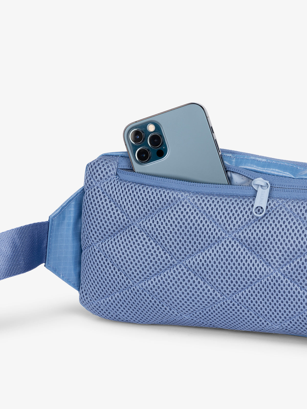 CALPAK Small travel sling bag with padded back and hidden zippered pocket in blue; BBT2301-GLACIER