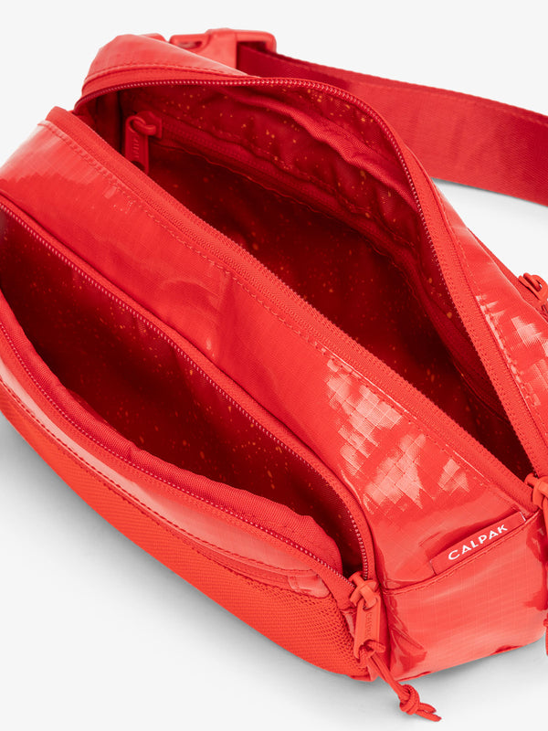 Terra hiking belt bag with multiple interior pockets and water resistant exterior in flaming red