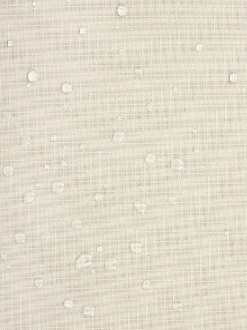 Water resistant material shown with water droplets on CALPAK Terra Zippered Passport Wallet in beige White Sands