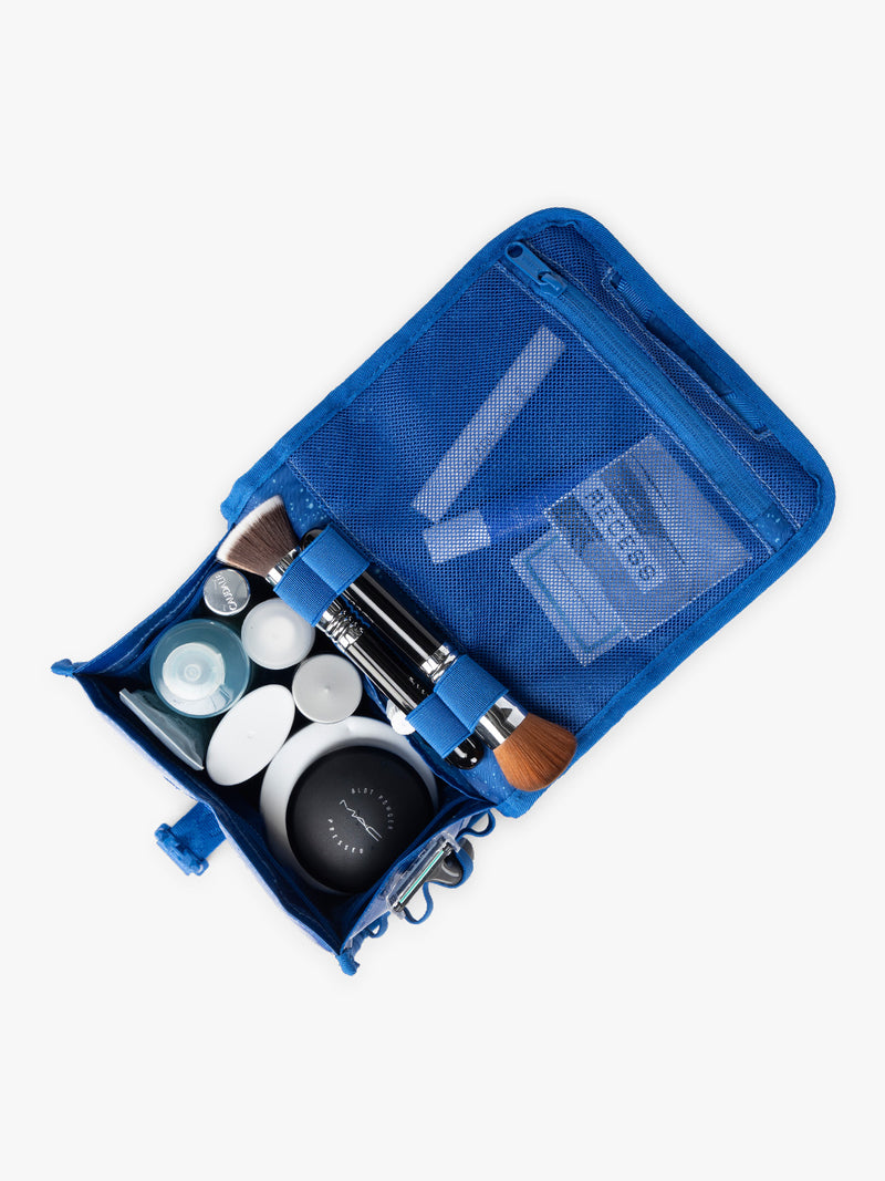 CALPAK Terra Hanging Toiletry Bag in blue Cobalt opened with items inside