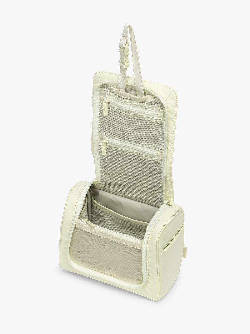 Opened CALPAK Luka Hanging Toiletry Bag in light green Celadon