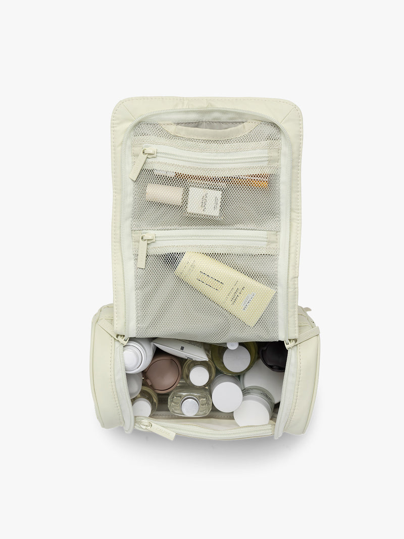 Toiletries in CALPAK Luka Hanging Toiletry Bag in light green Celadon