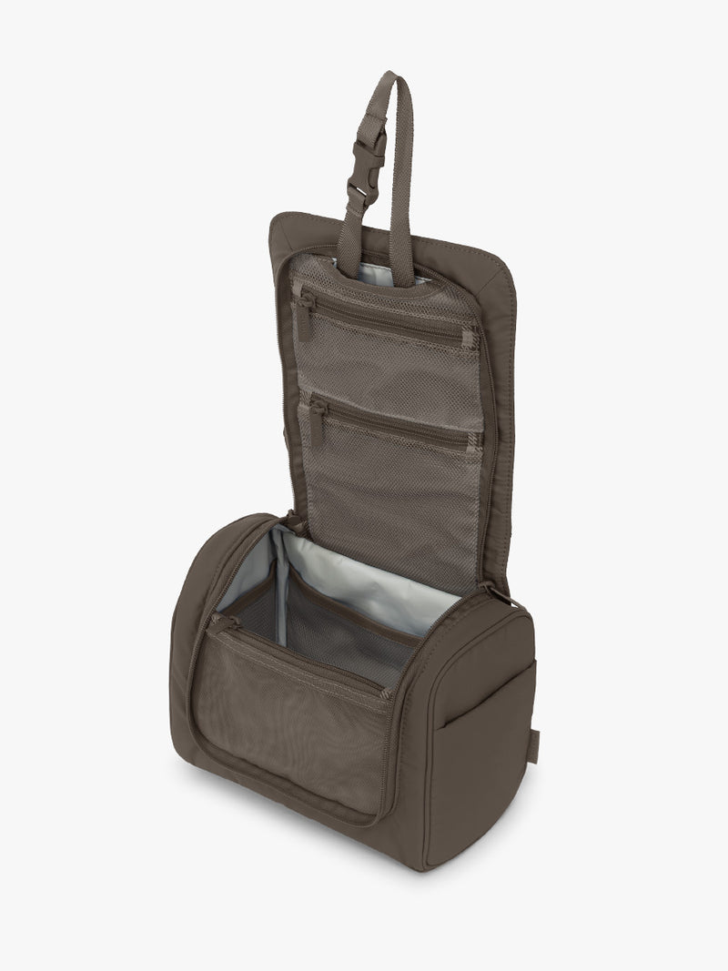 Opened CALPAK Luka Hanging Toiletry Bag in brown Mushroom