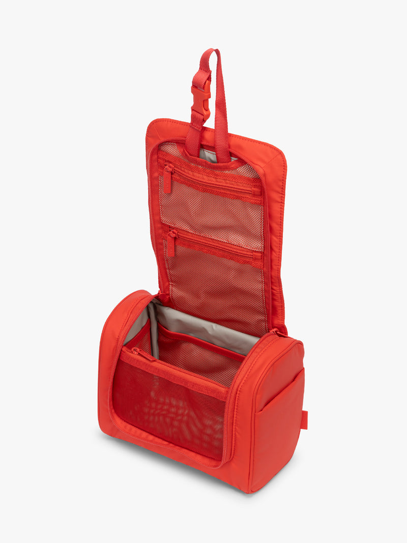Opened CALPAK Luka Hanging Toiletry Bag in red Tomato