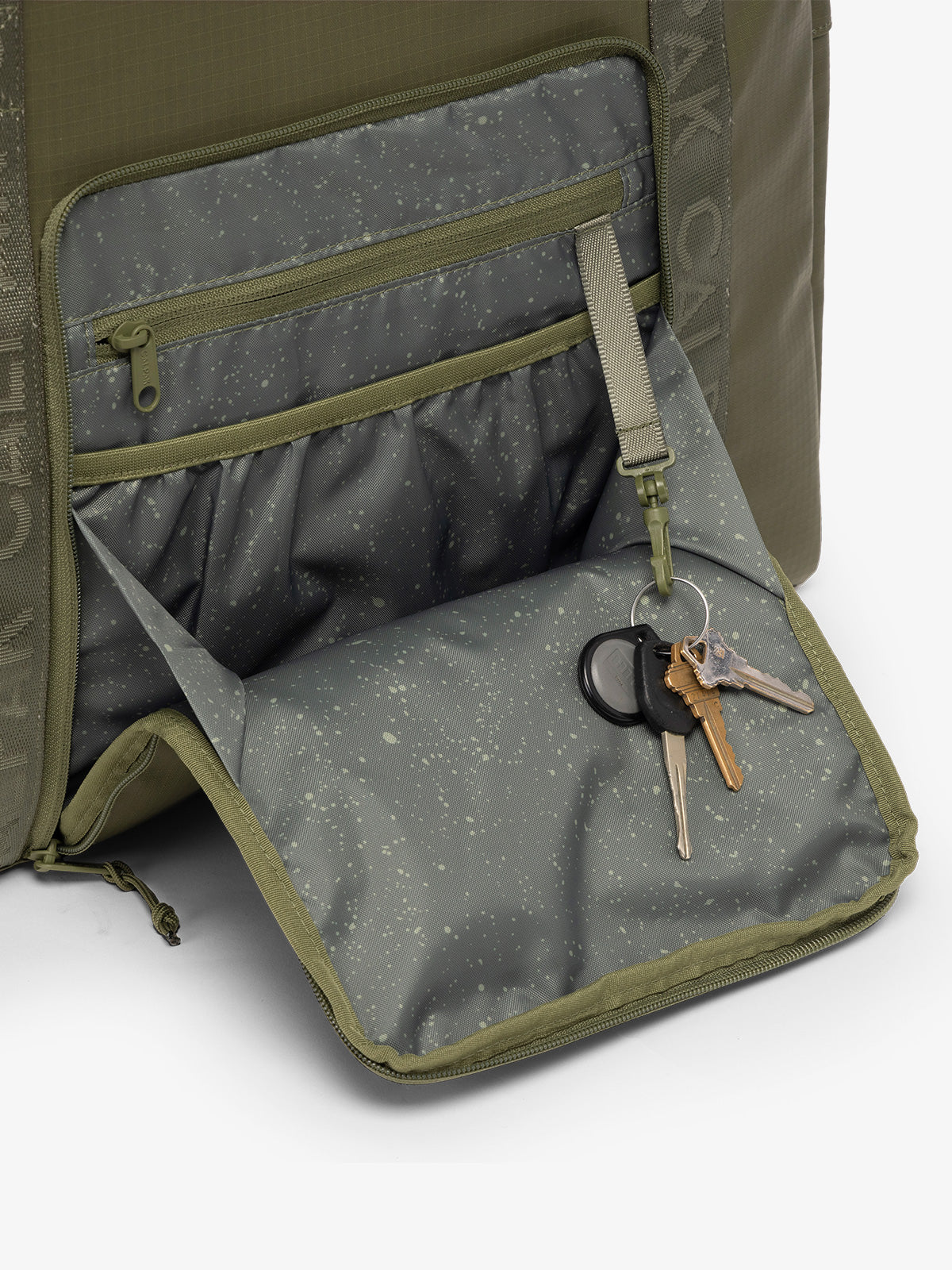 CALPAK Terra 35L Water Resistant Zippered Tote Bag in dark green Matte Pine front pocket detail; TTO2401-PINE