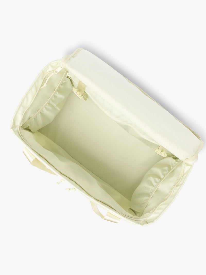 Top opened view of CALPAK Terra 35L Tote Bag with multiple pockets and shoulder straps in shiny light green Celadon on a white background