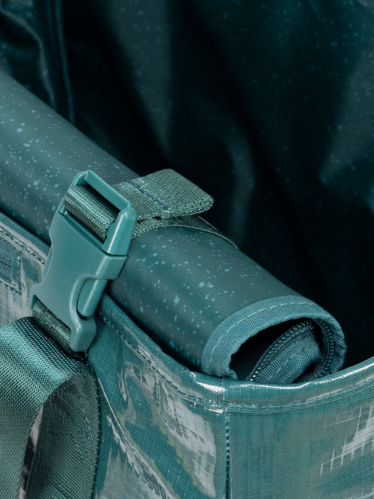 Rollable top of CALPAK Terra 35L Tote Bag with zippers in blue green Kale on a white background; TTO2401-KALE