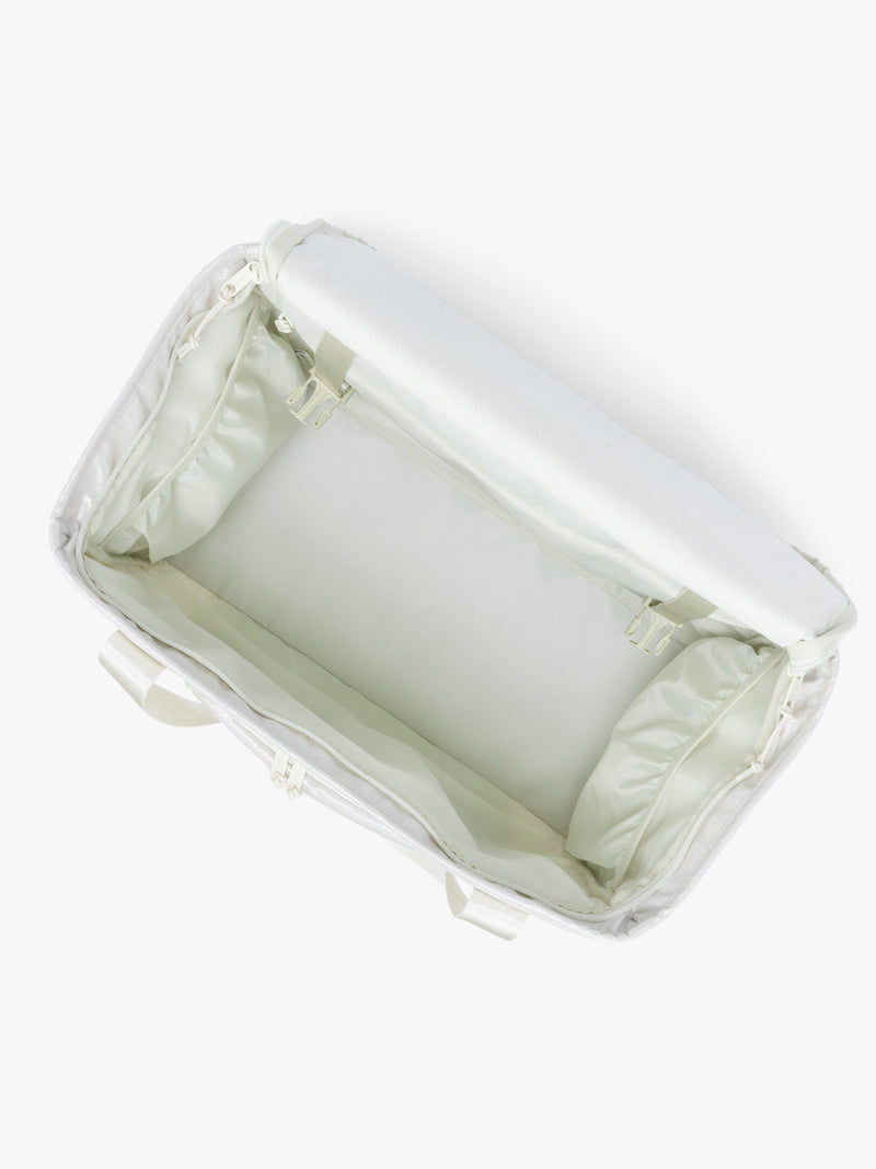 Top opened view of CALPAK Terra 35L Tote Bag with multiple pockets and shoulder straps in shiny white Moonbeam on a white background