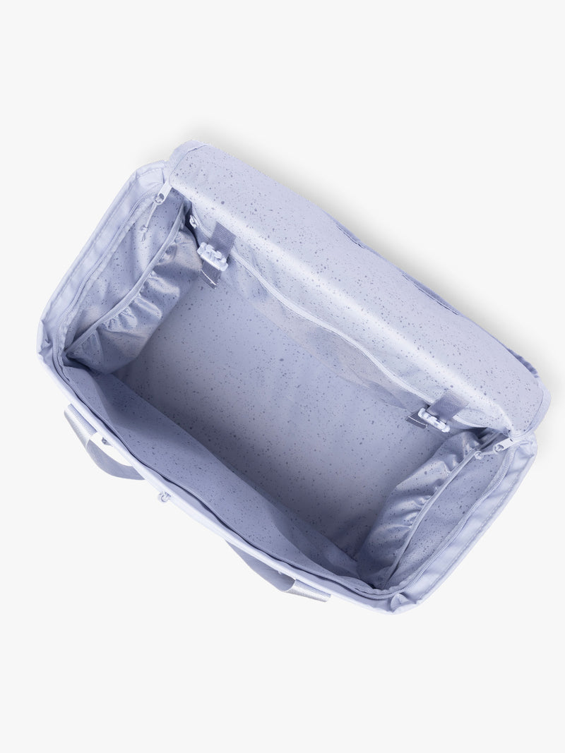 Top opened view of the CALPAK Terra 35L Tote Bag with multiple pockets and shoulder straps in shiny light lavender Sea Glass on a white background