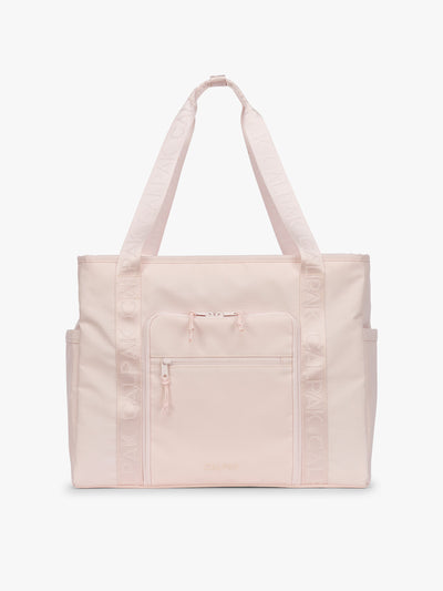CALPAK Terra 35L Tote Bag with multiple pockets and shoulder straps in shiny light pink Shell Pink on a white background; TTO2401-SHELL-PINK view 1