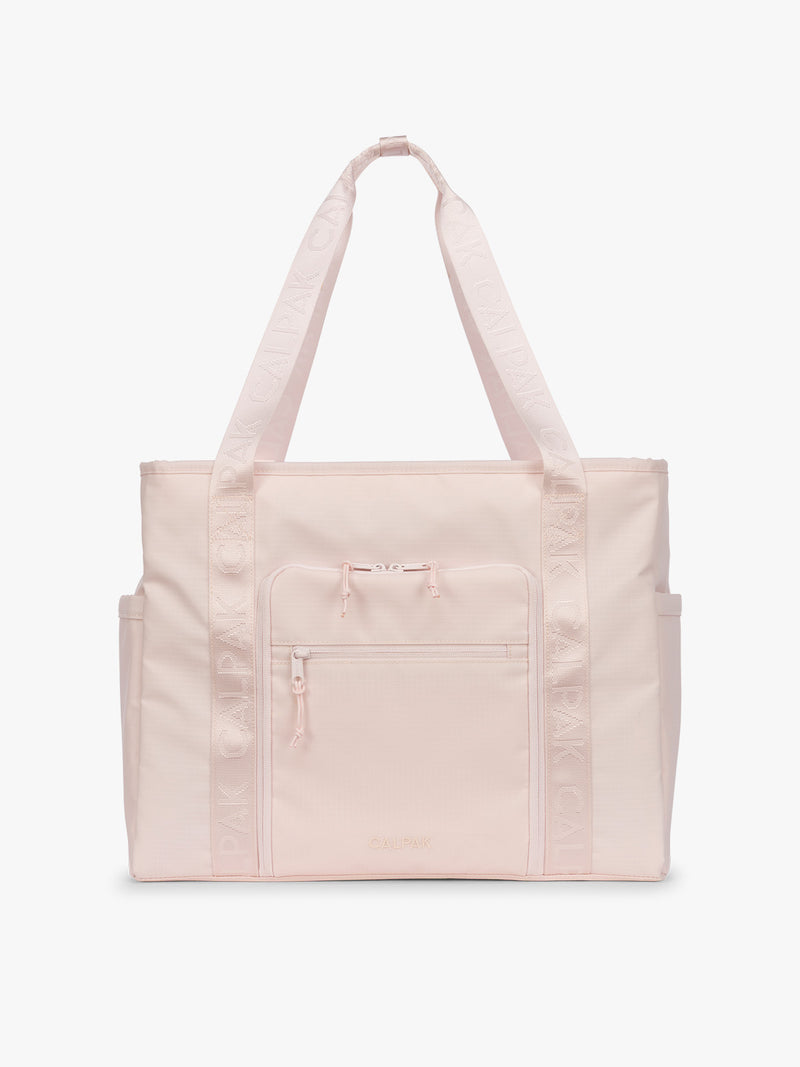 CALPAK Terra 35L Tote Bag with multiple pockets and shoulder straps in shiny light pink Shell Pink on a white background