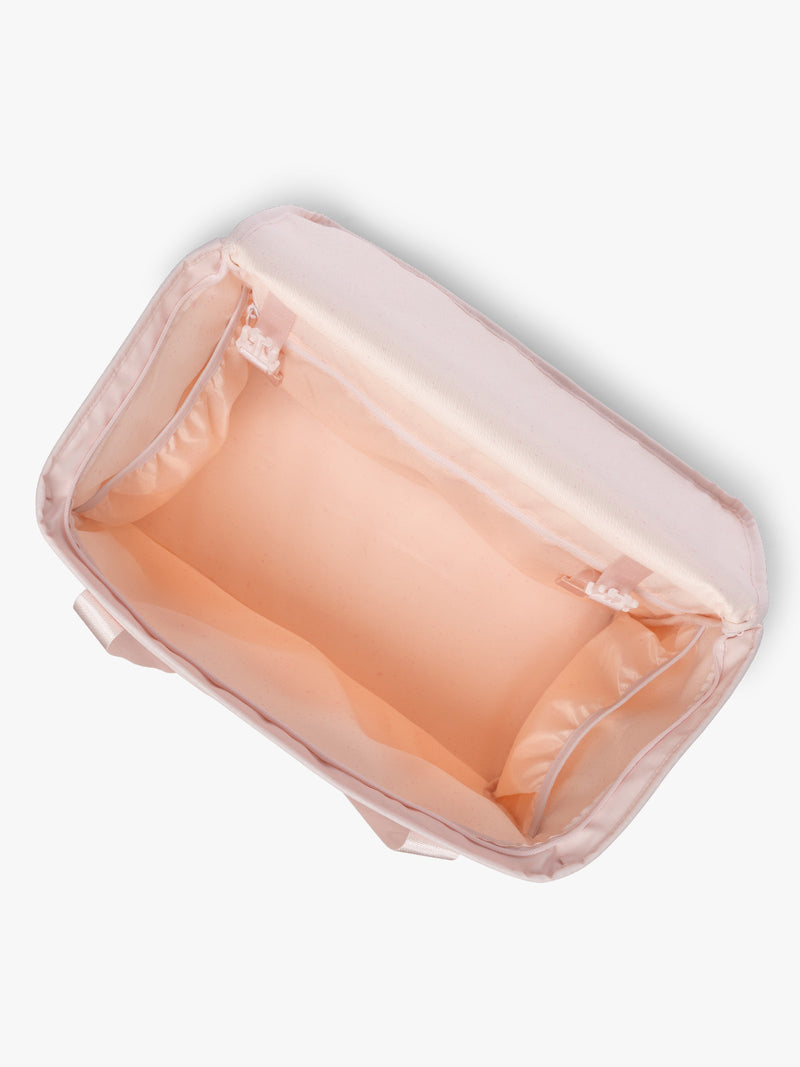 Top opened view of CALPAK Terra 35L Tote Bag with multiple pockets and shoulder straps in shiny light pink Shell Pink on a white background