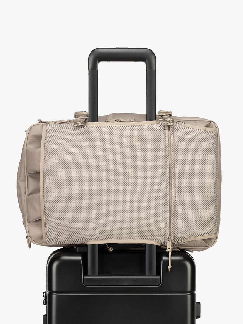 CALPAK Terra 26L Laptop Duffel Backpack in beige Stone trolley sleeve view