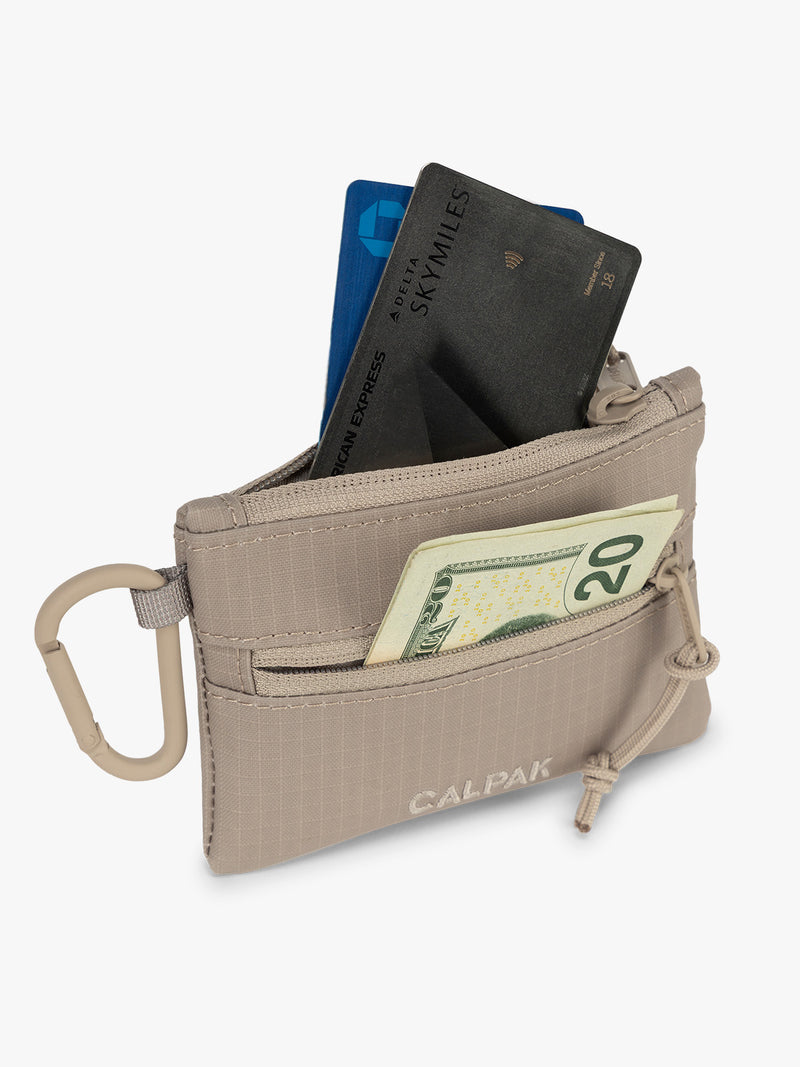 CALPAK Terra Clippable Card Pouch in beige Stone filled with cards and cash