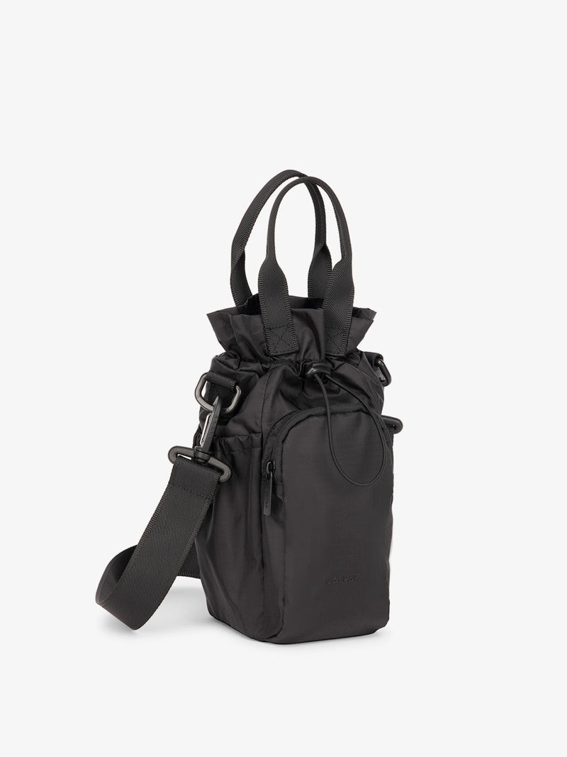 The Water Bottle Holder in black, featuring an adjustable shoulder strap, designed to carry water bottles hands-free
