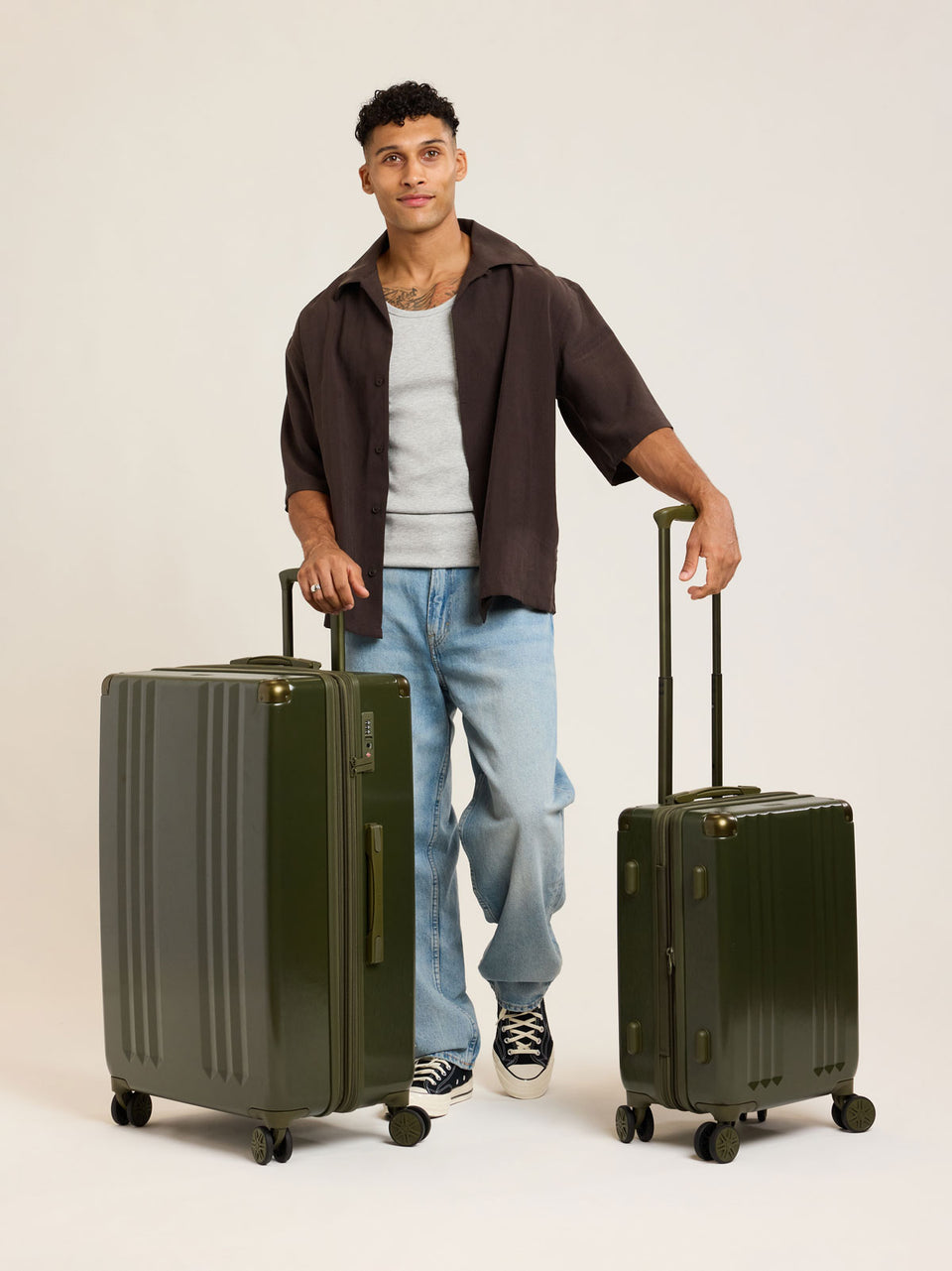 Model with CALPAK dark green Pine 2pc Luggage Set; LAM2000-PINE