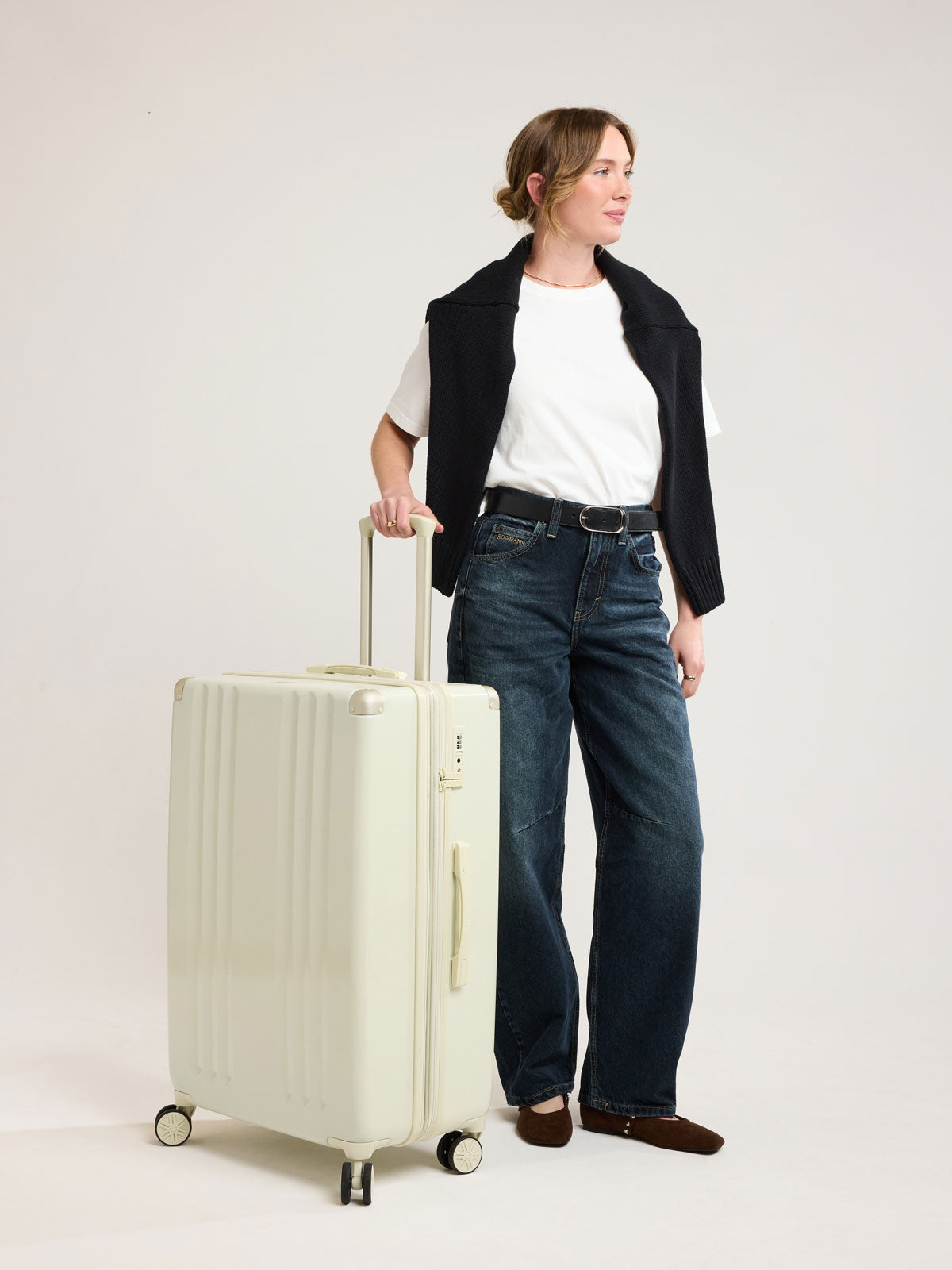 Woman with CALPAK Ambeur Large Luggage in light green Celadon; LAM1028-CELADON