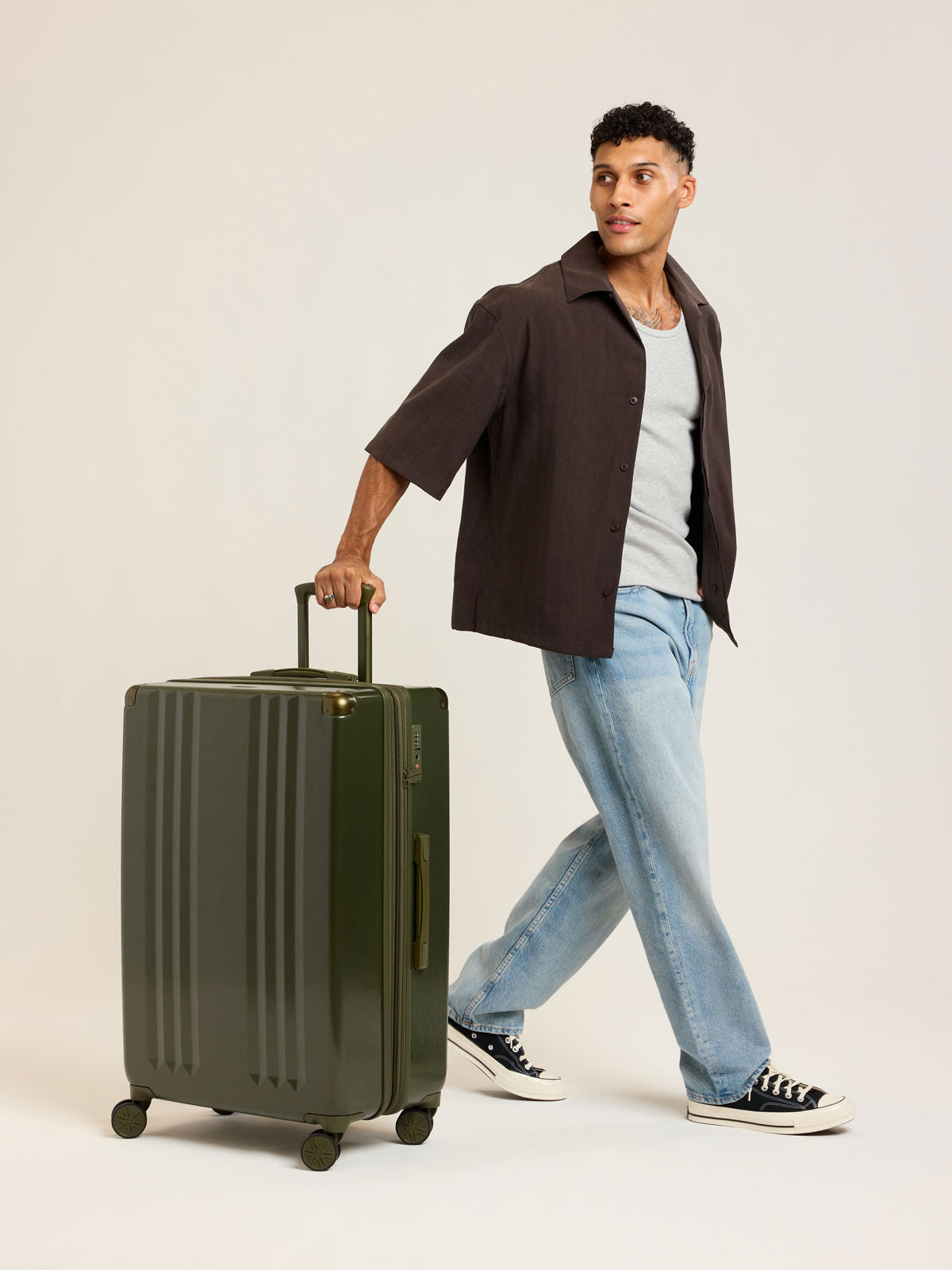 Model wtih CALPAK Ambeur Large Luggage in dark green Pine; LAM1028-PINE