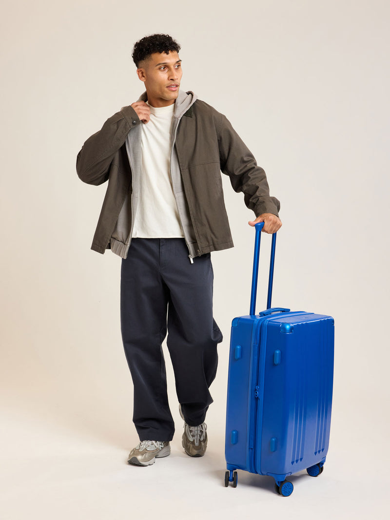 Model with CALPAK Ambeur Medium Luggage in dark blue Cobalt