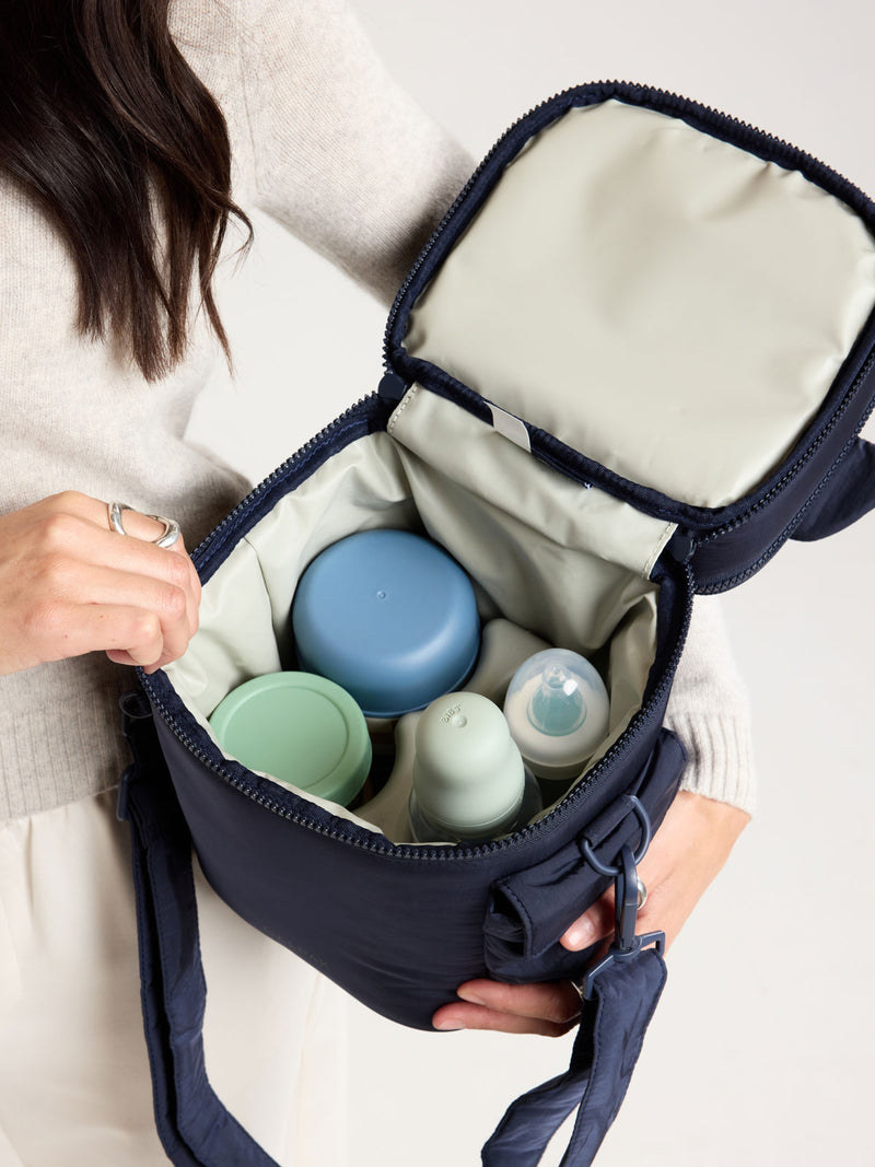 Bottles in the CALPAK Insulated Baby Bottle Bag in blue navy