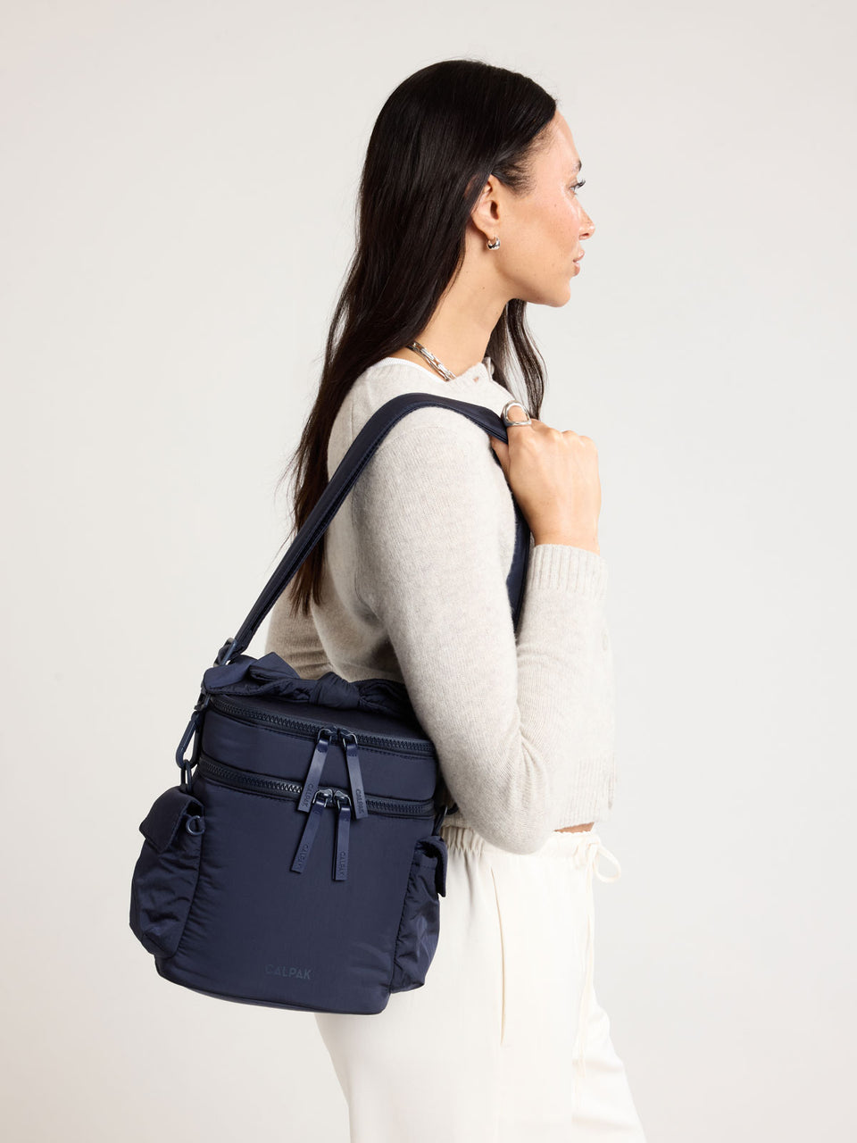 Woman wearing the CALPAK Insulated Baby Bottle Bag in blue navy ; IBB2601-NAVY