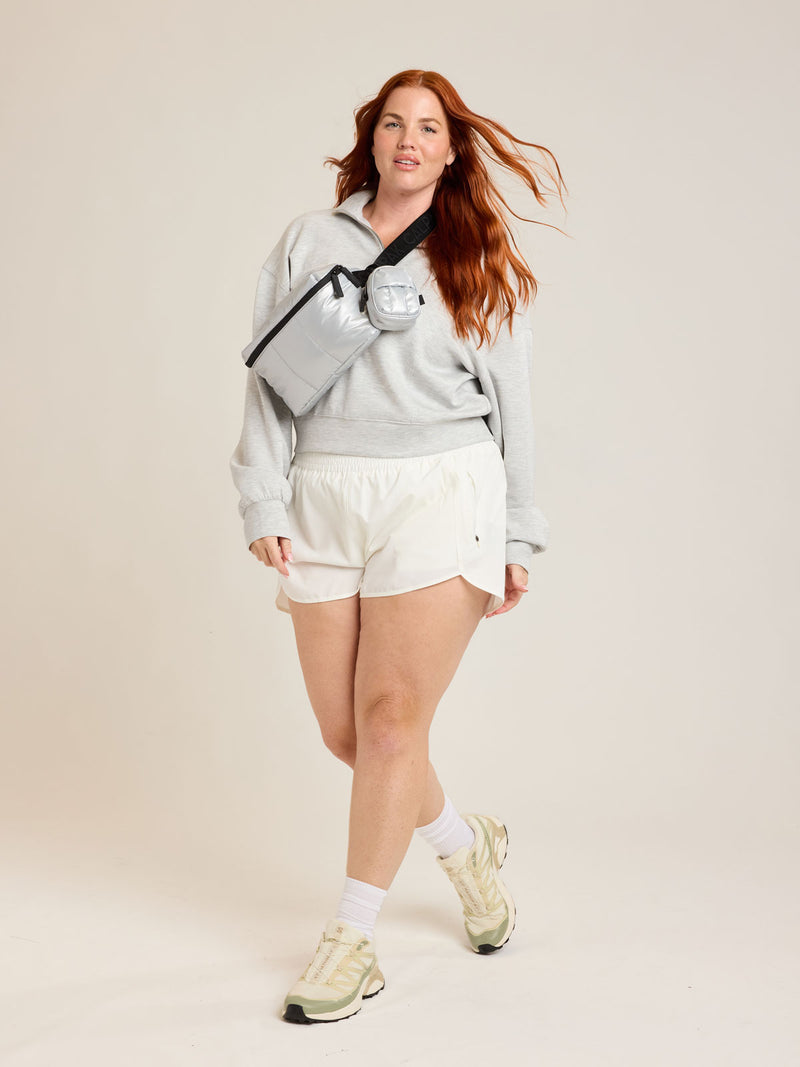 Model wearing the CALPAK Luka Belt Bag in Silver