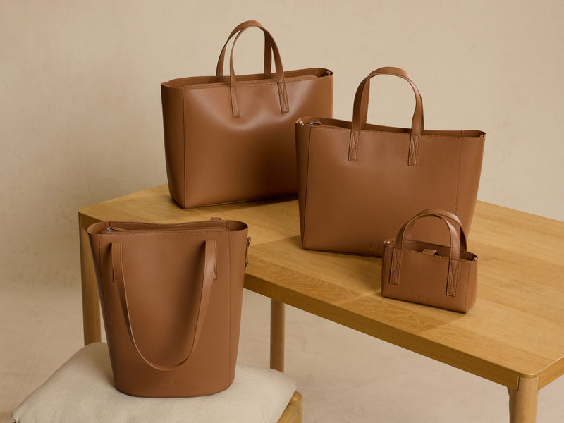 CALPAK Haven collection with 14" Bucket Bag, 15" Laptop Tote, 16" Laptop Tote, and Mini Tote in brown Taupe