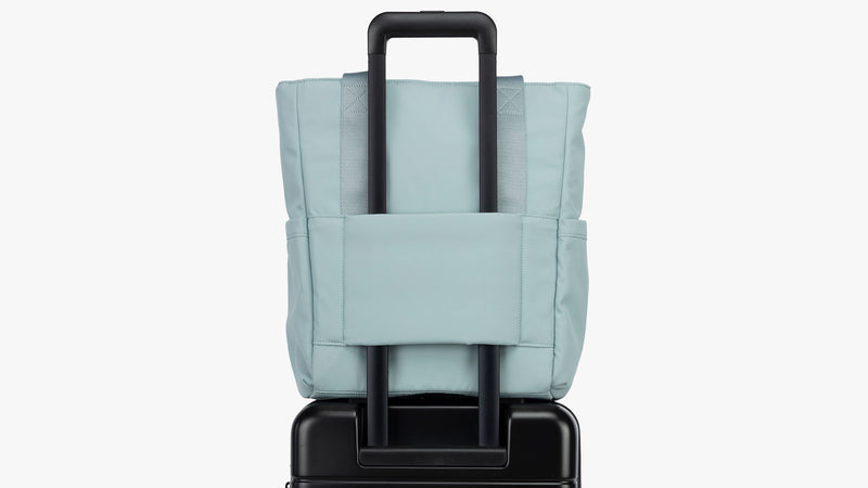 CALPAK Connect Zippered Laptop Tote in light blue Bluebell with luggage trolley sleeve