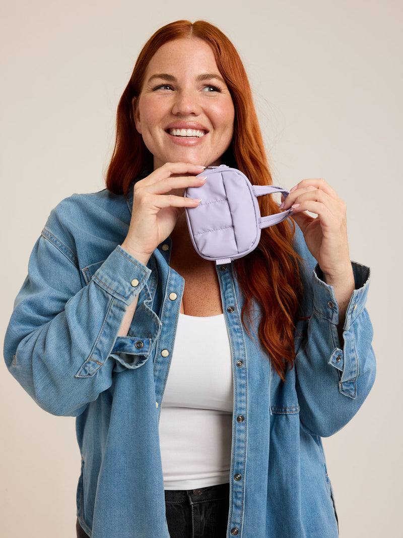 Model with CALPAK Luka Duffel Zip Bag Charm in lavender Orchid