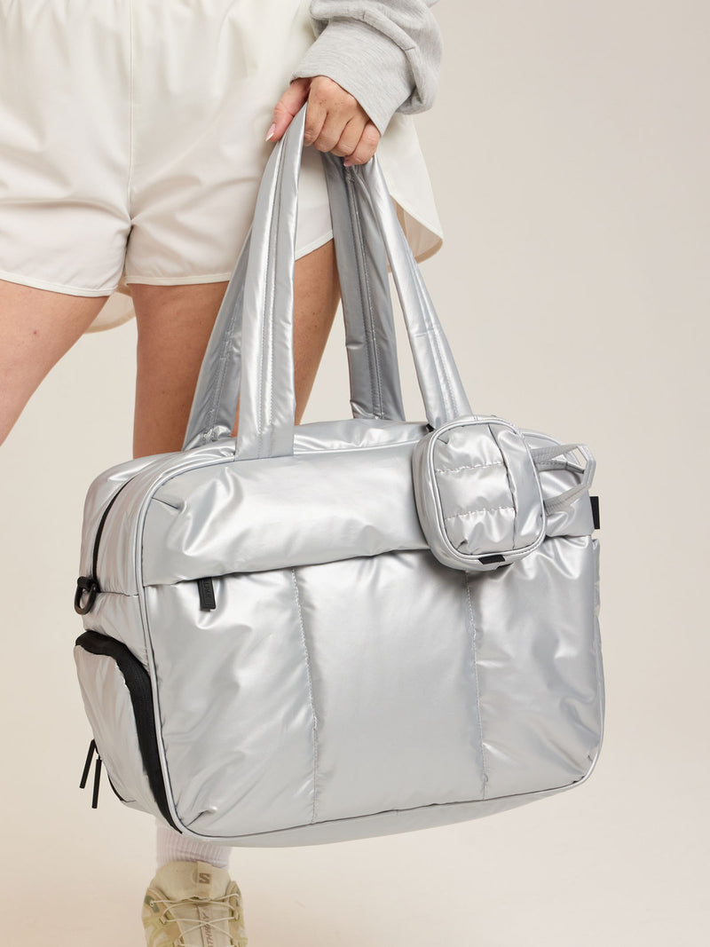 CALPAK Luka Duffel Key Pouch in Silver attached to the CALPAK Luka Duffel in Silver
