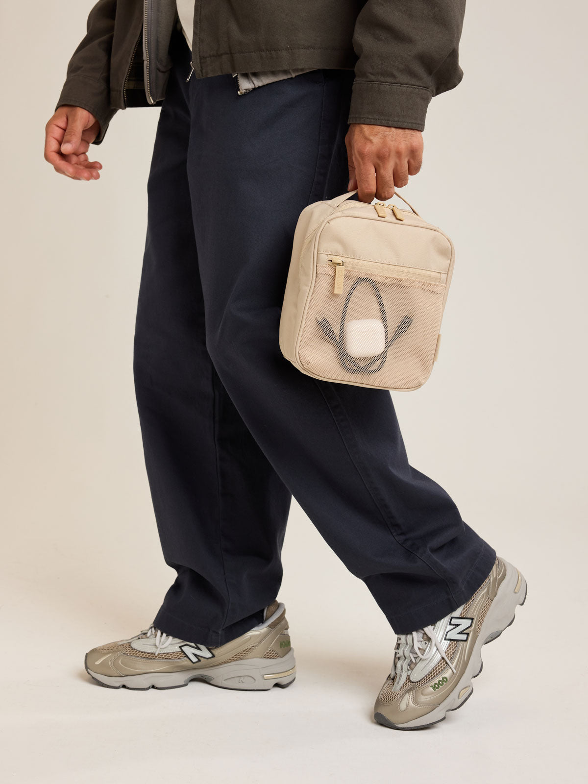 Model holding CALPAK Everything Cube in beige Oatmeal; ACE2401-OATMEAL
